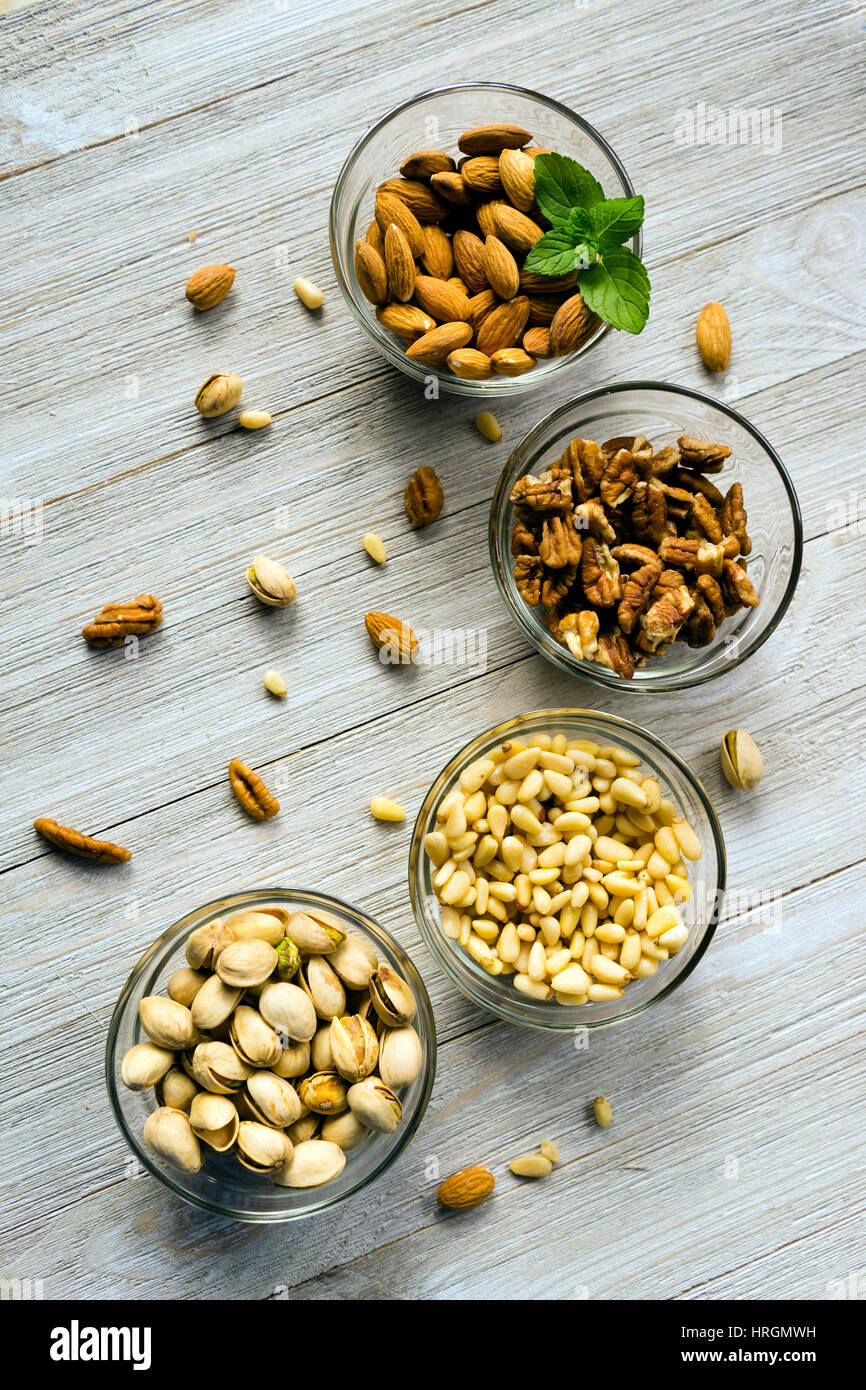 Healthy snacks of nuts in ramekins on a wood table Stock Photo Alamy