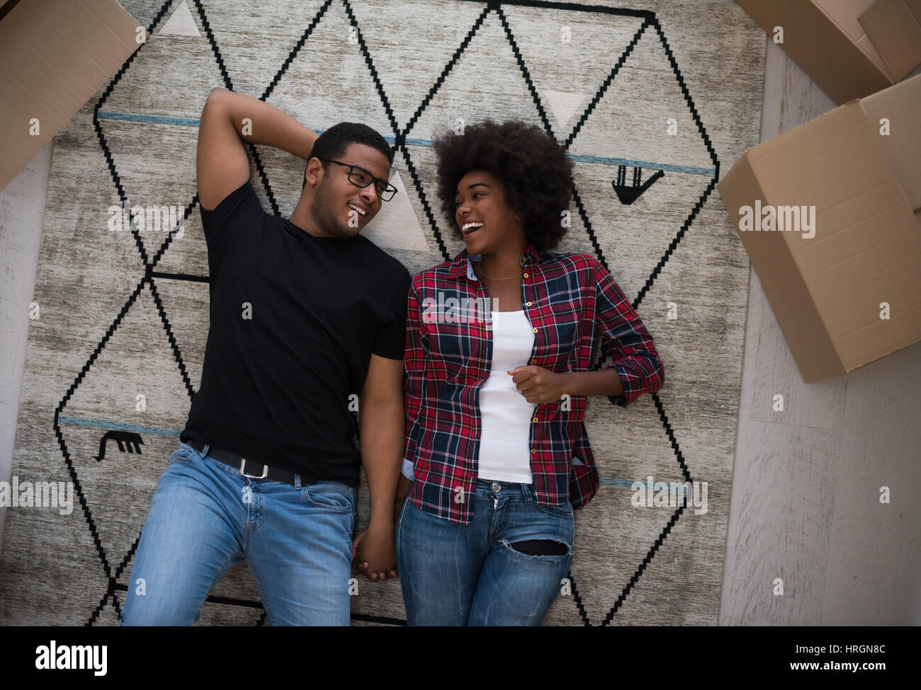 Top view of attractive young African American couple moving, holding ...