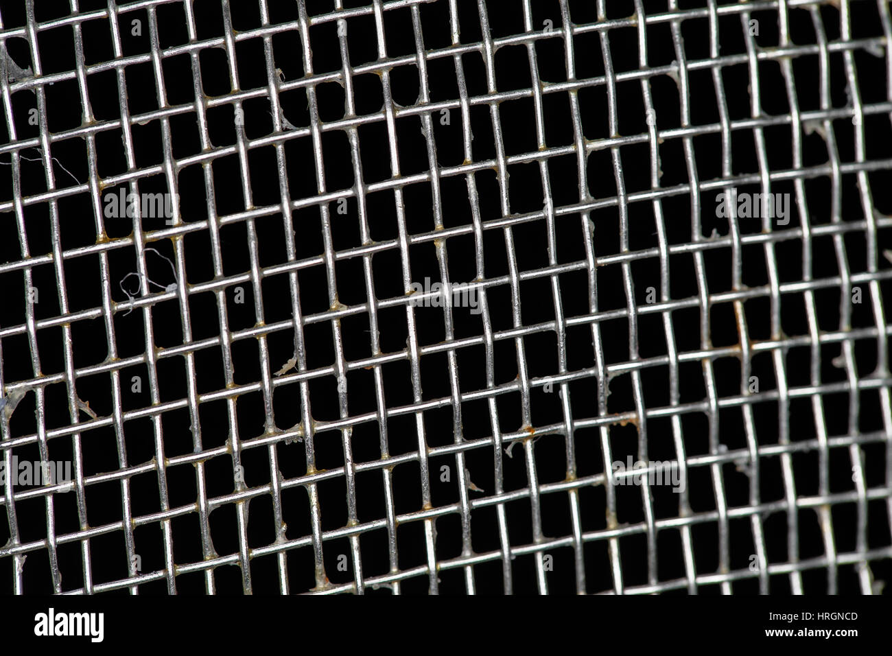 dirty metallic noodle sieve texture on black background Stock Photo