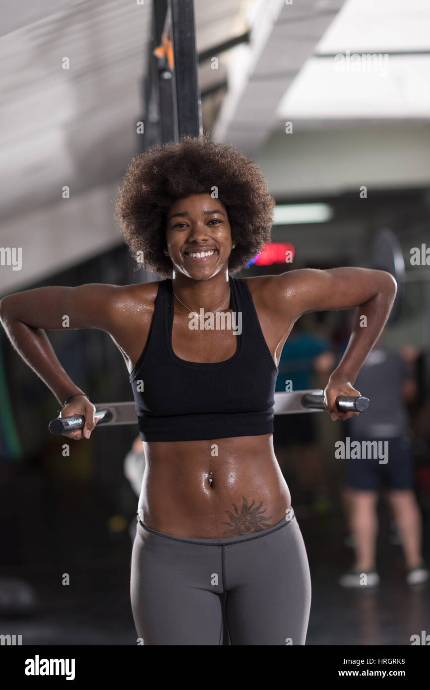 African American woman doing triceps exercises in the gym, close-up,  cardio, weight loss, beautiful Stock Photo by Gerain0812