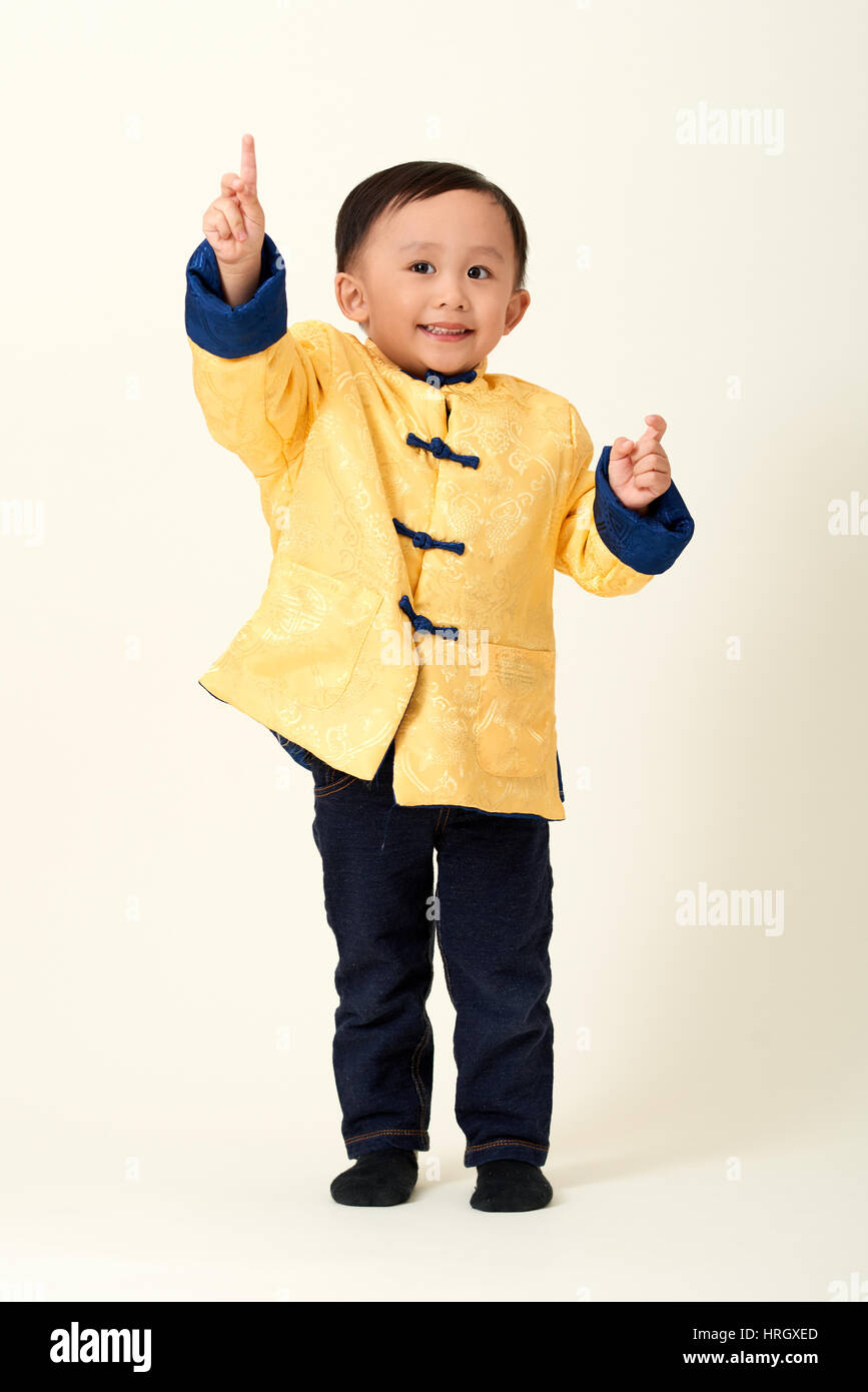 Chinese baby boy in traditional Chinese New Year outfit celebrating