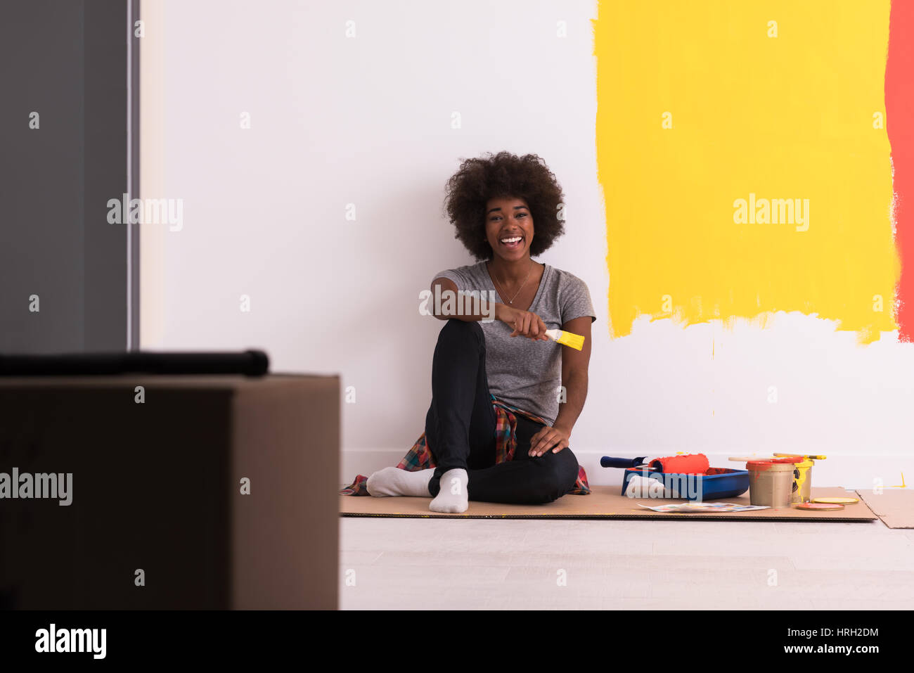 Portrait of a beautiful african american female painter sitting on ...