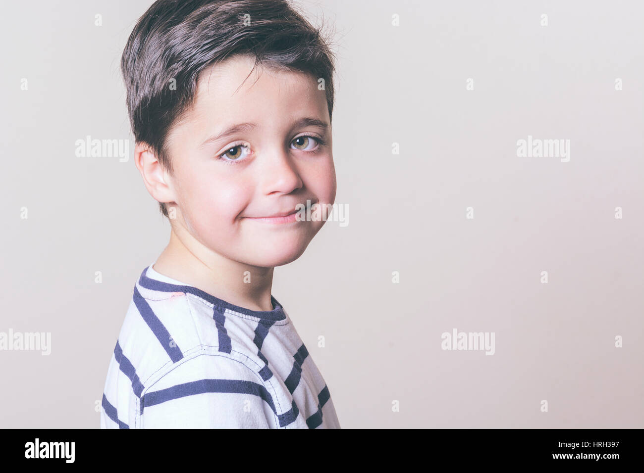 Happy child with hat looks at camera Stock Photo