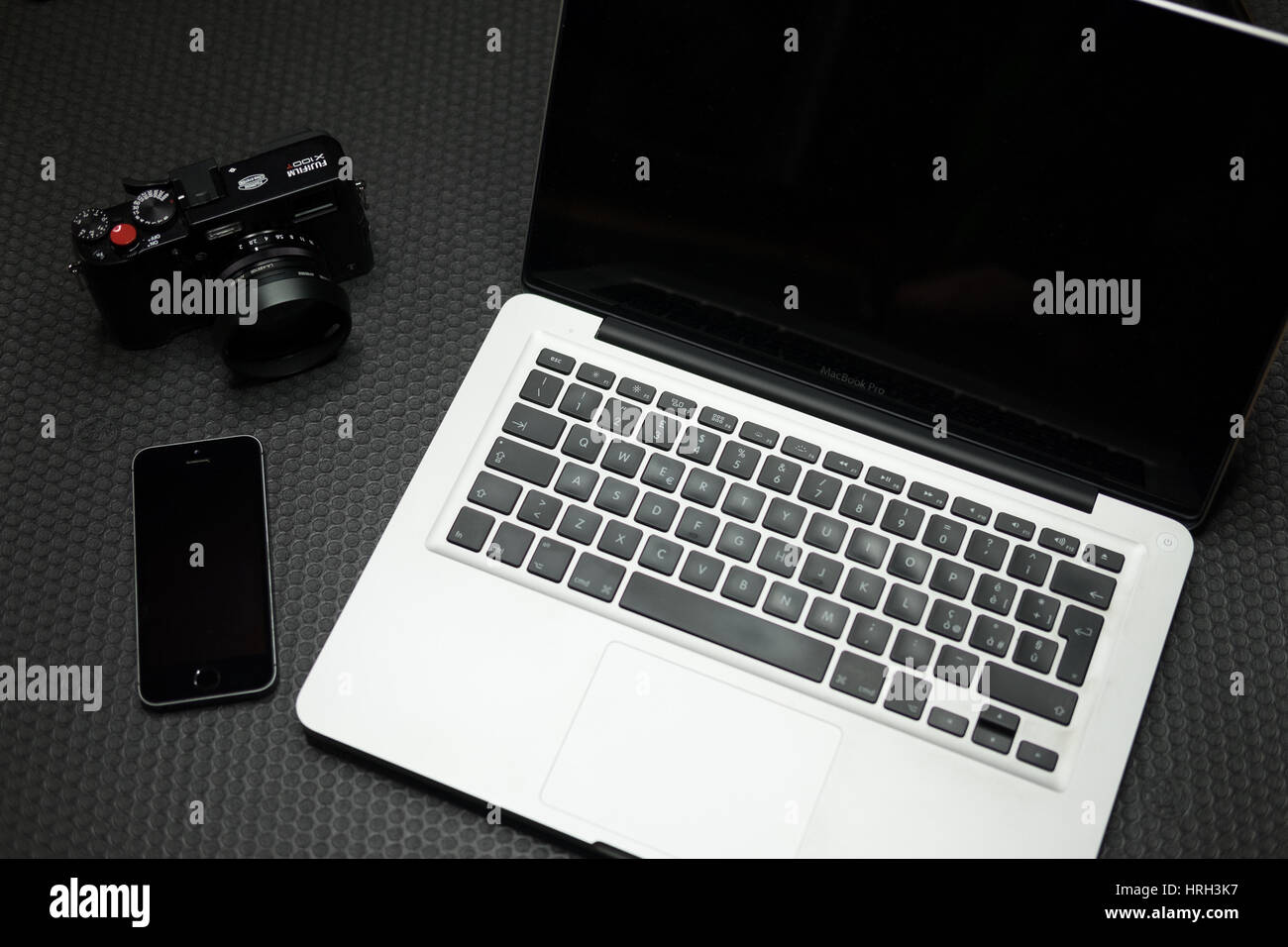High tech laptop, smartphone and digital camera against 'stealth' backdrop. Stock Photo