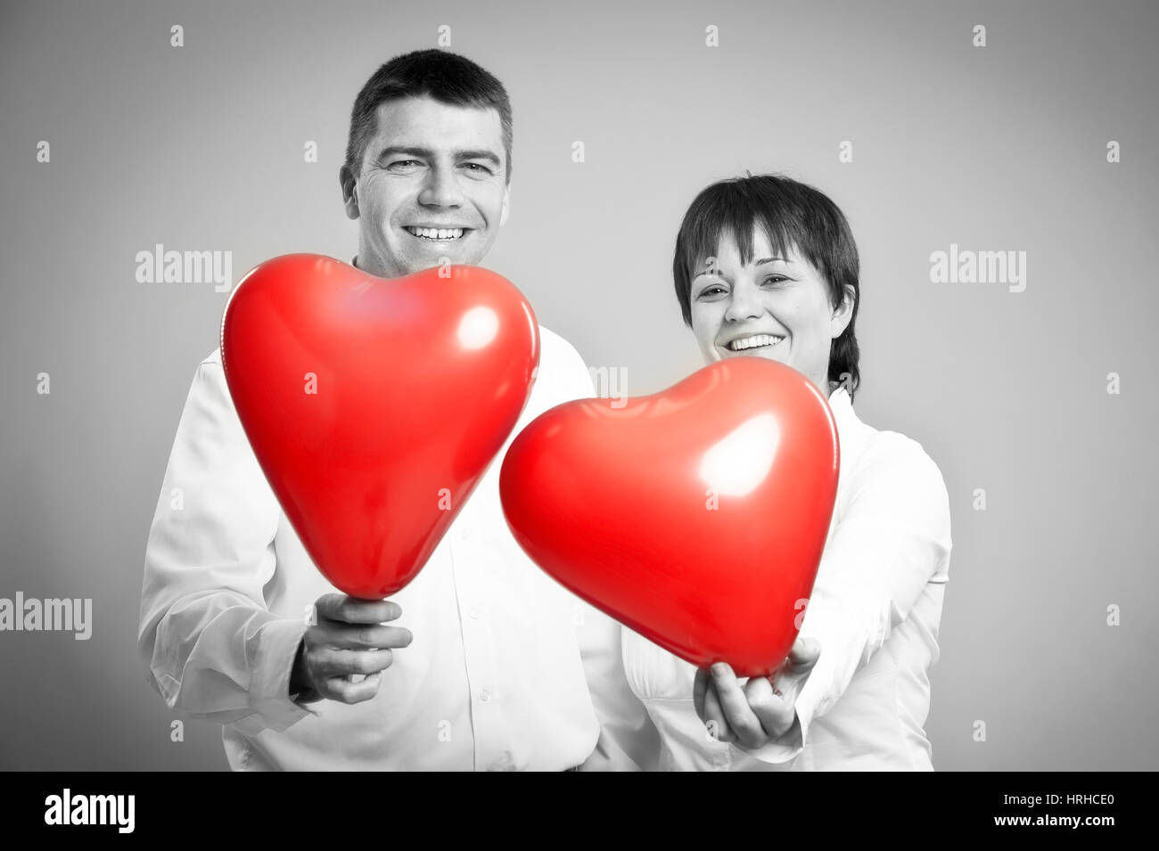 Paar mit Herzluftballonen - couple with heart balloons Stock Photo