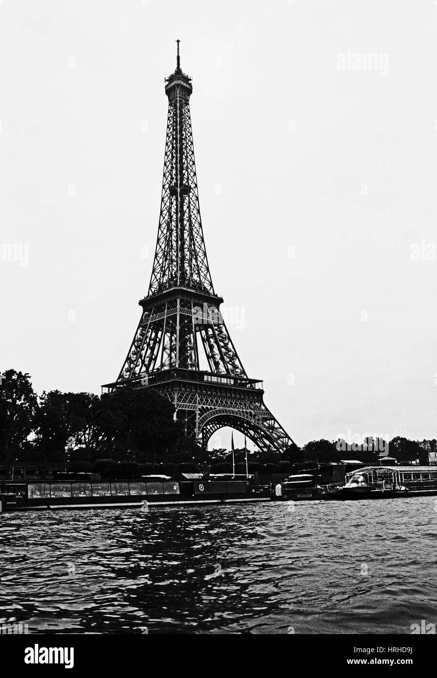 Eiffel Tower in Paris from the River Seine in black and white with the contrast kicked up for a stark image. Stock Photo