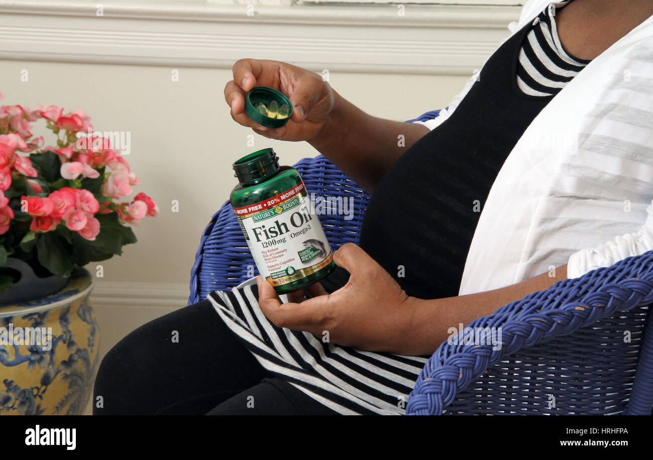 Pregnant Woman Taking Fish Oil Supplements Stock Photo Alamy