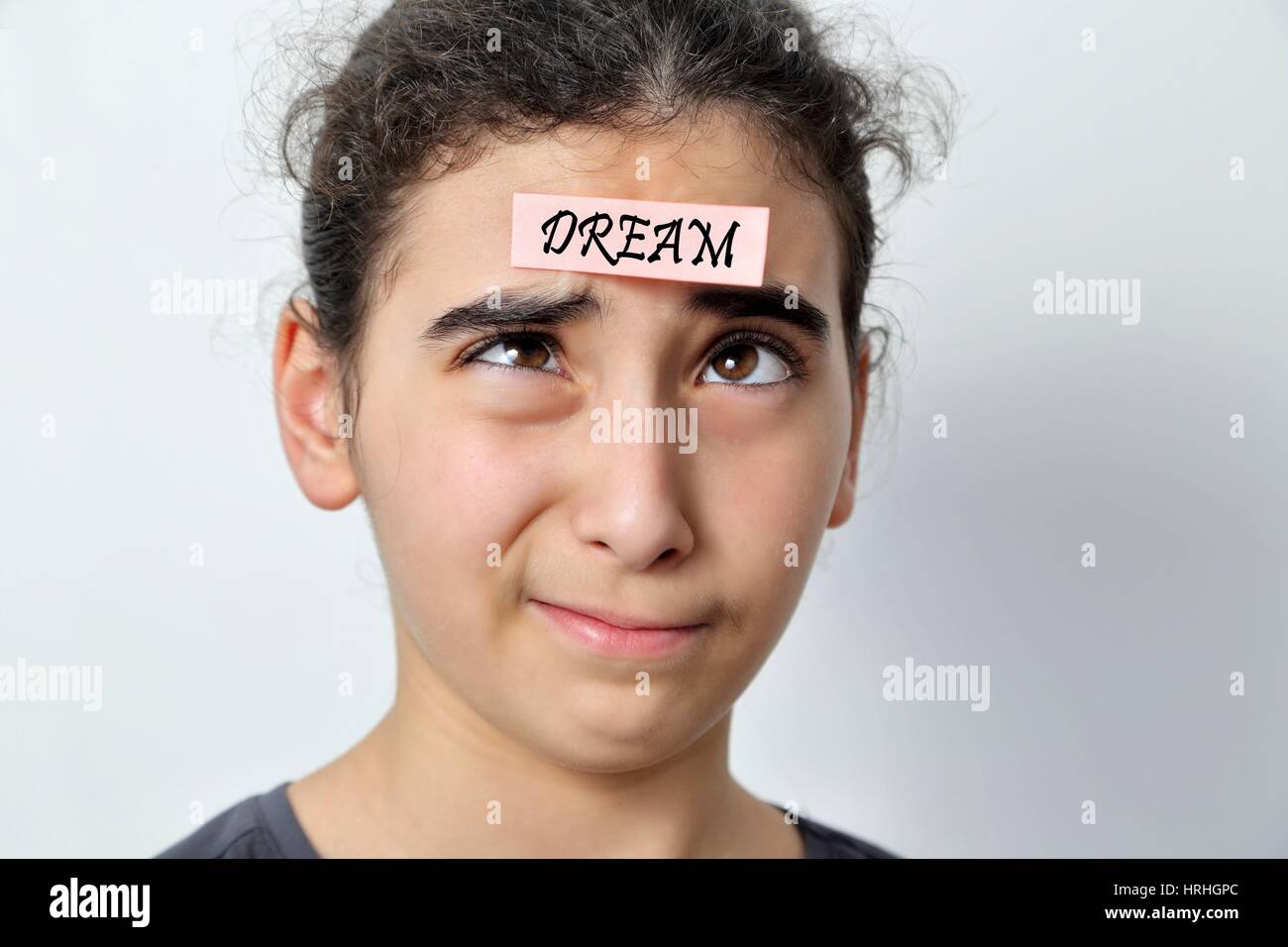 Little girl with memo posts on her forehead, with motivational message Stock Photo