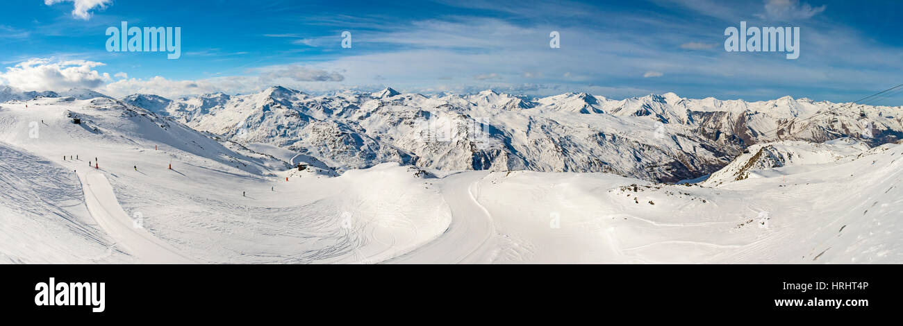 Ski slope piste in winter alpine resort with european alps mountain range in background Stock Photo