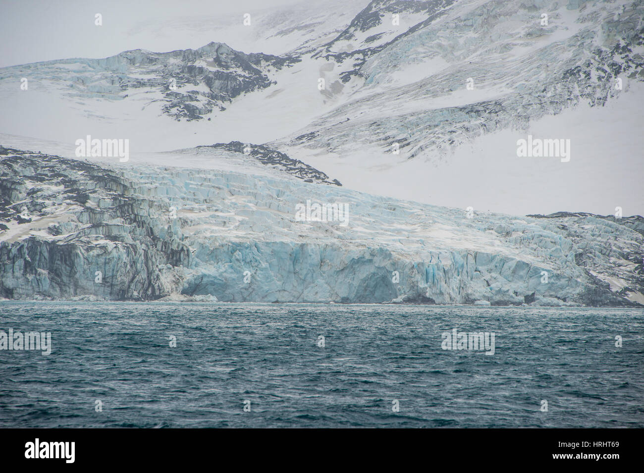 Glacier flowing down a mountain on Elephant Island, South Shetland Islands, Antarctica, Polar Regions Stock Photo