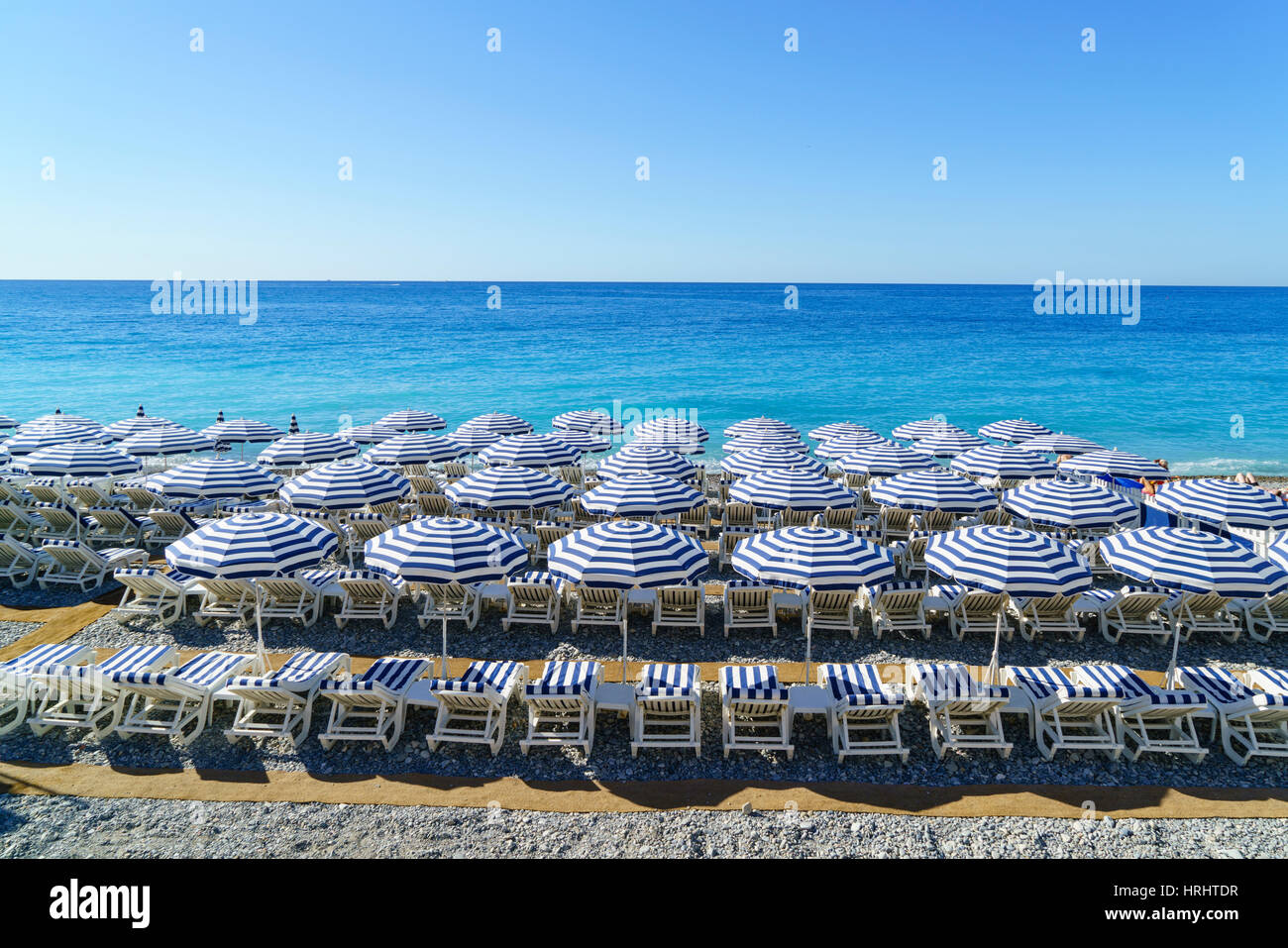 Blue and white beach parasols, Nice, Alpes-Maritimes, Cote d'Azur, Provence, French Riviera, France, Mediterranean Stock Photo
