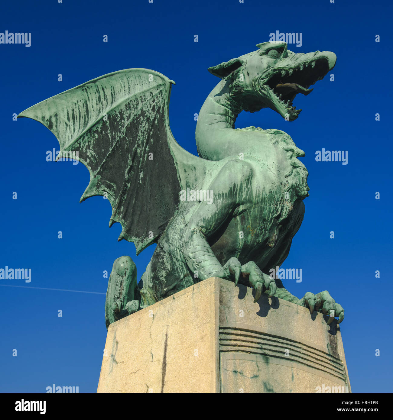 LJUBLJANA, SLOVENIA - FEBRUARY 19, 2017: Statue on Dragon Bridge over Ljubljanica river in Ljubljana, capital of Slovenia. It was originally named The Stock Photo