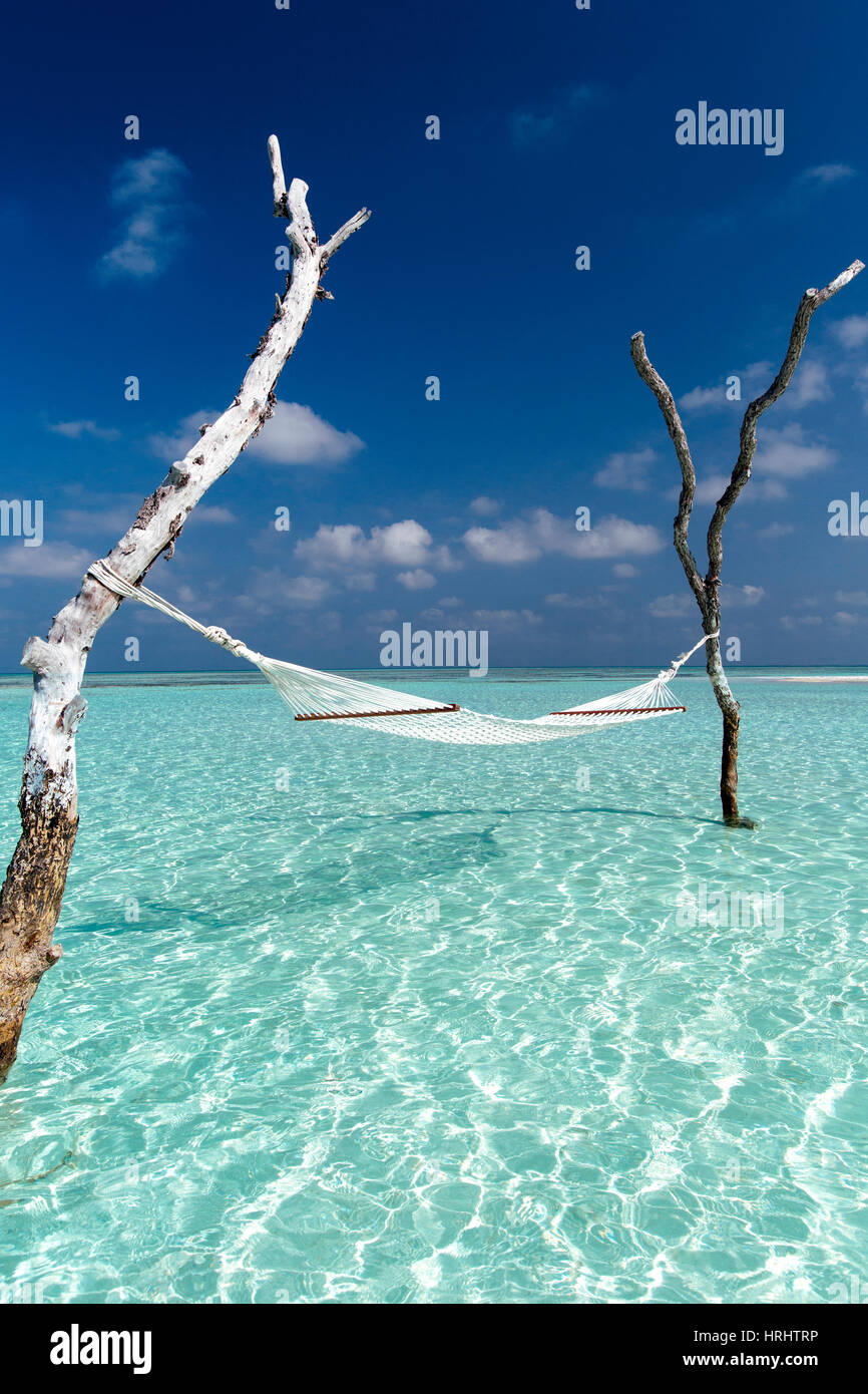 Hammock over the waters of a tropical lagoon, The Maldives, Indian Ocean, Asia Stock Photo