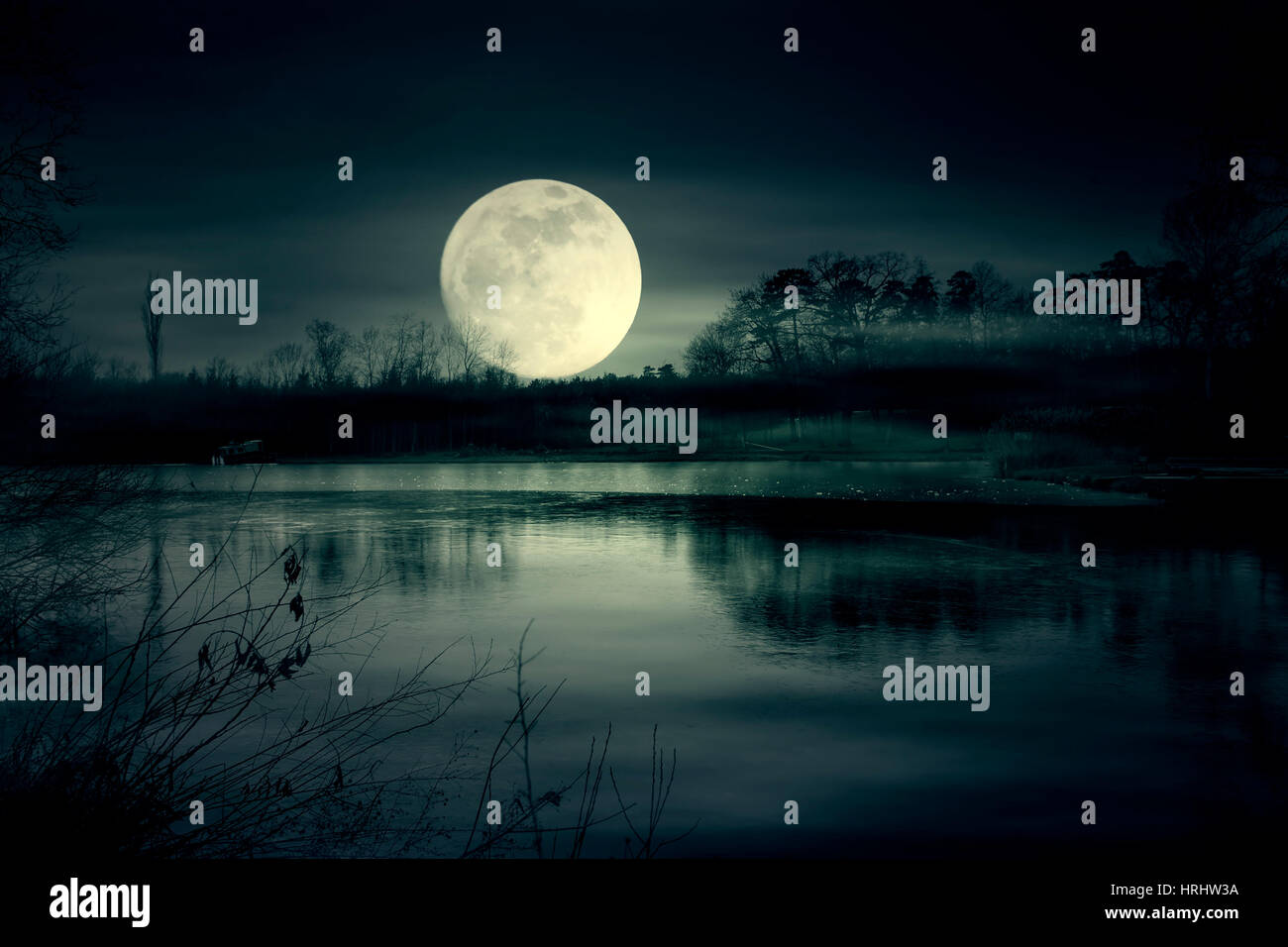 Super moon and lake at night Stock Photo
