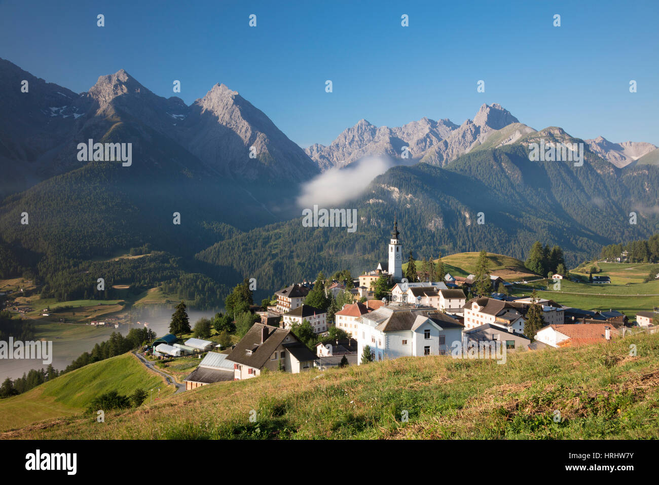 Green meadows frame the the alpine village of Ftan, Inn district, Canton of Graubunden, Engadine, Switzerland Stock Photo