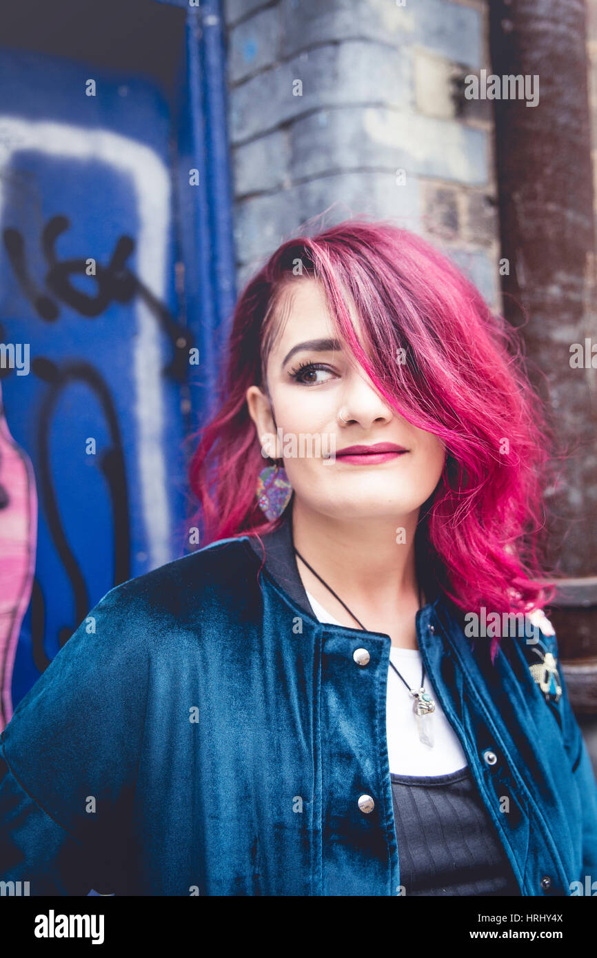 Woman with pink hair and brown eyes Stock Photo
