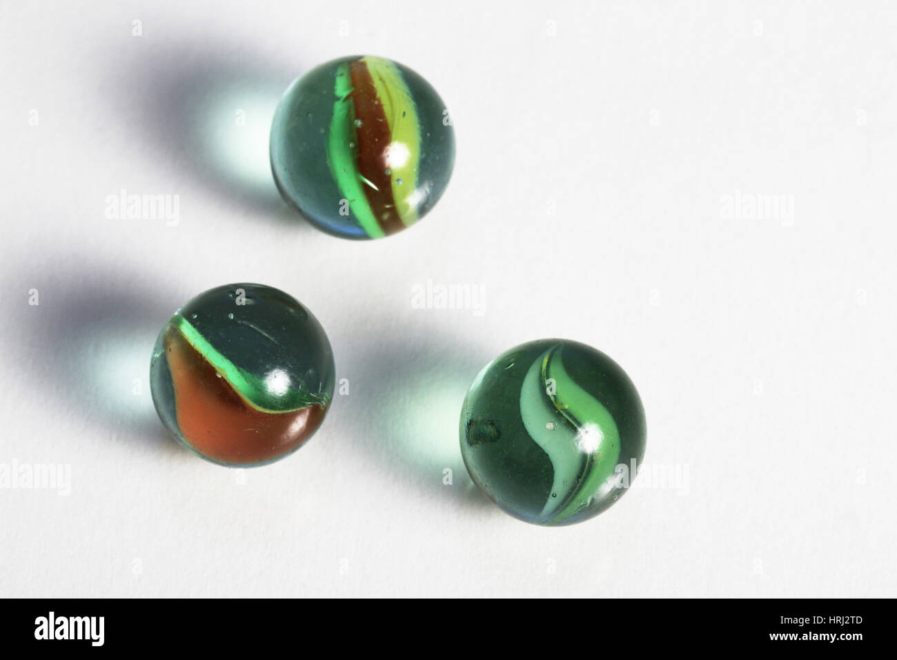 Red marbles one green marble hi-res stock photography and images - Alamy