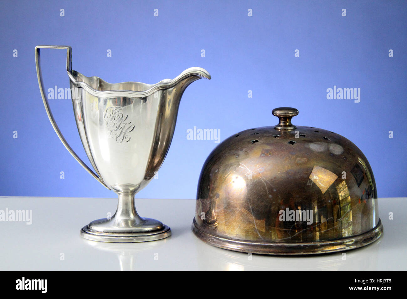 Polished Cup and Tarnished Cake Dome Stock Photo