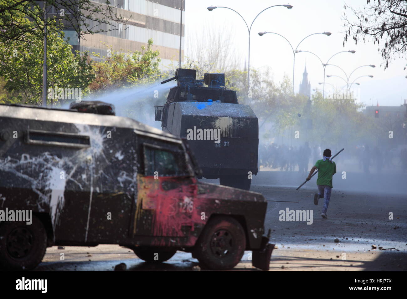 police water cannon disperse protesters,during a student strike in Santiago's Downtown, Chile. Stock Photo