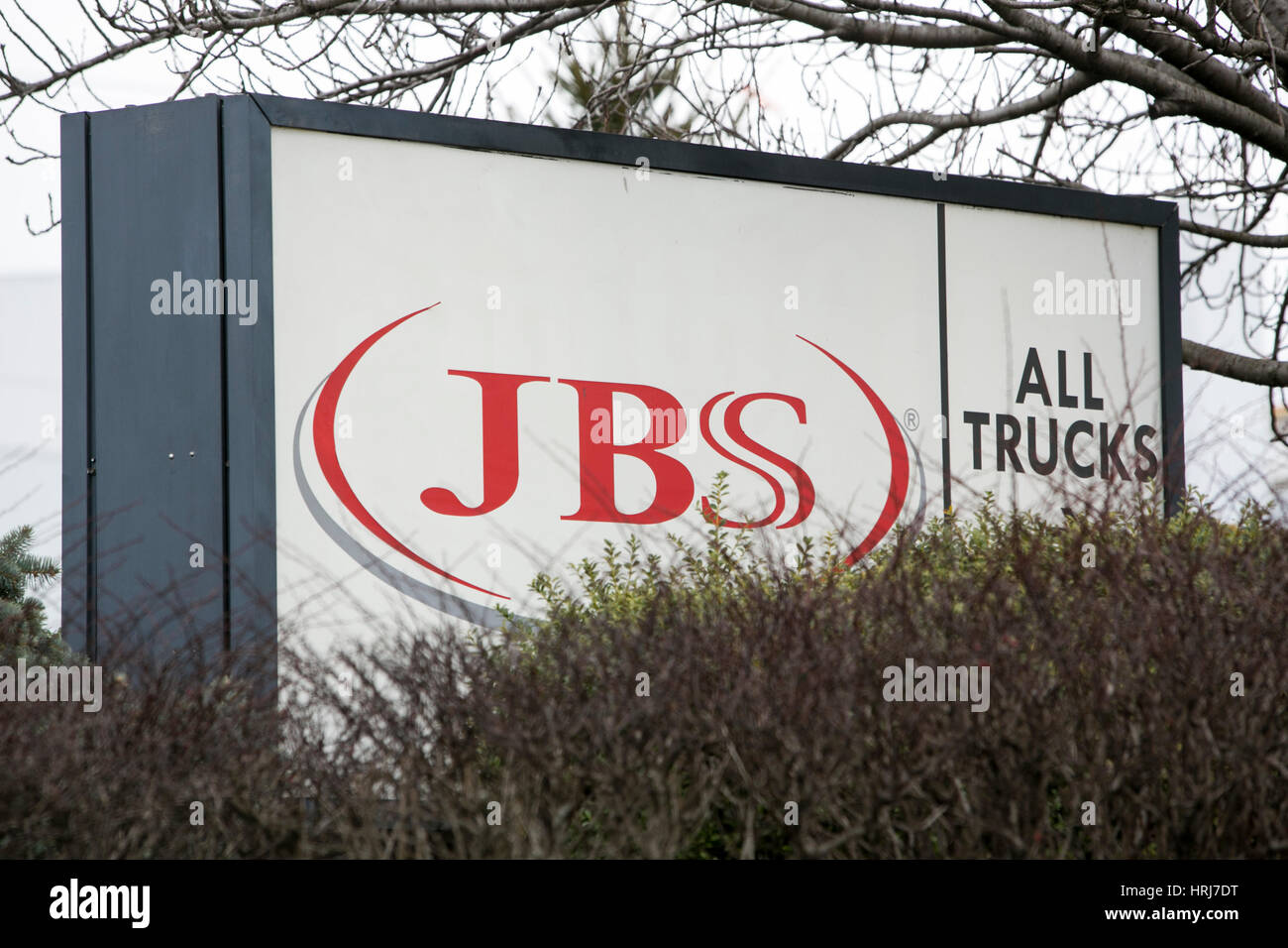 A logo sign outside of JBS USA Holdings, Inc., meat packing plant in