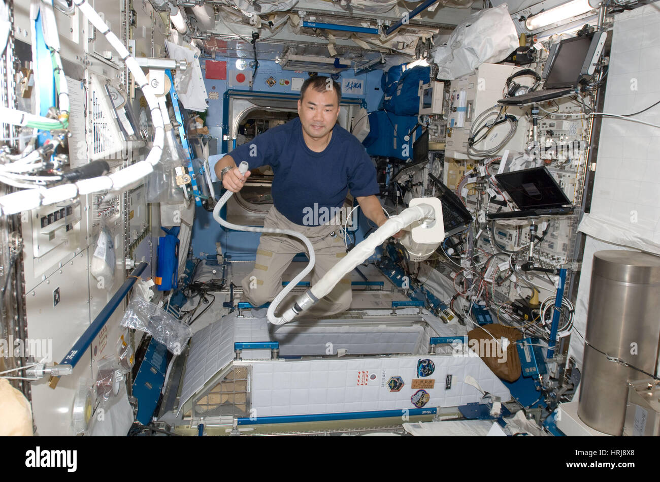 Astronaut Using Vacuum Cleaner at the ISS Stock Photo Alamy