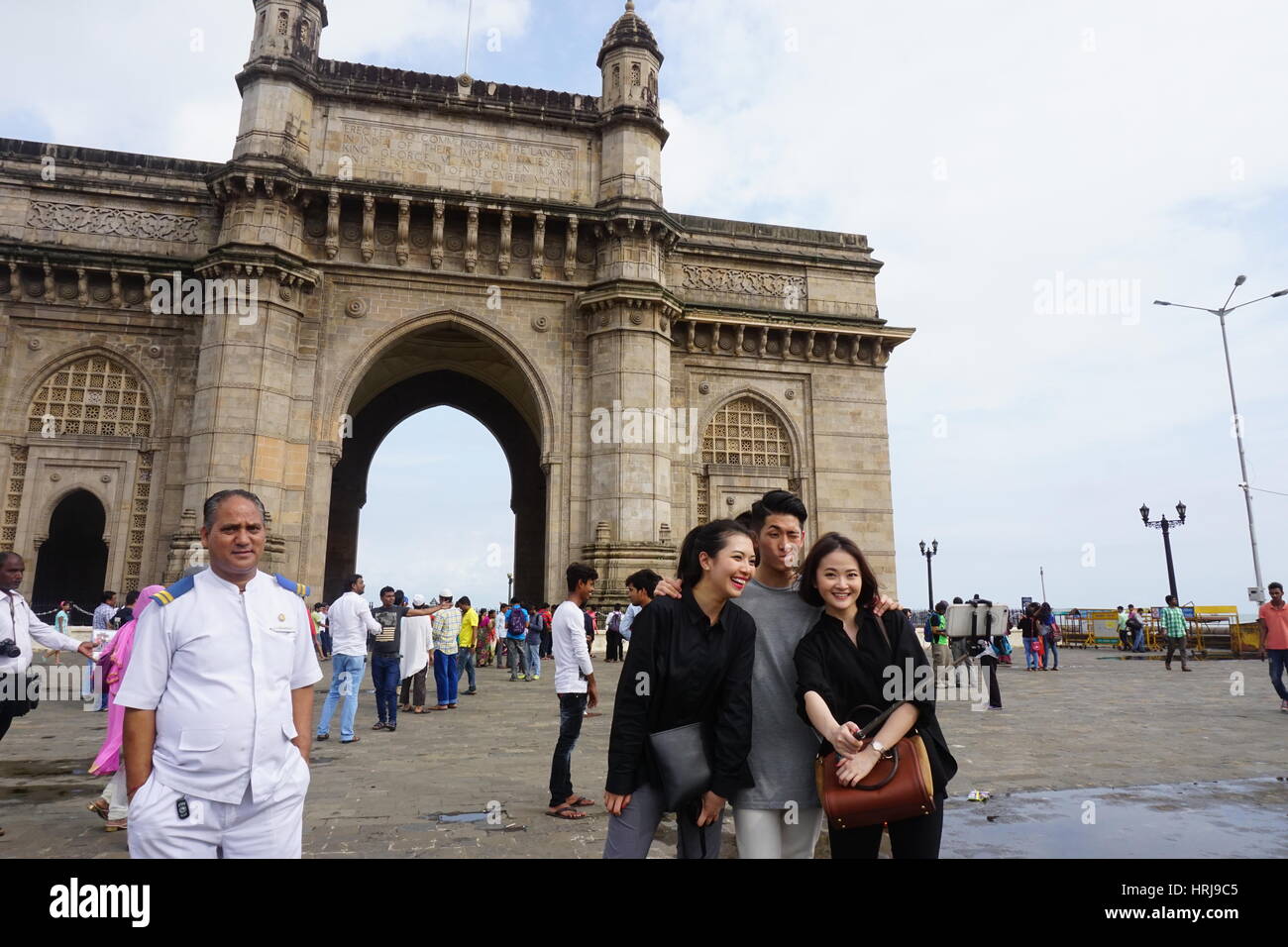 Tourist are taking selfies at Gateway of India in Mumbai. There faces expressions attracted to take pics of them Stock Photo