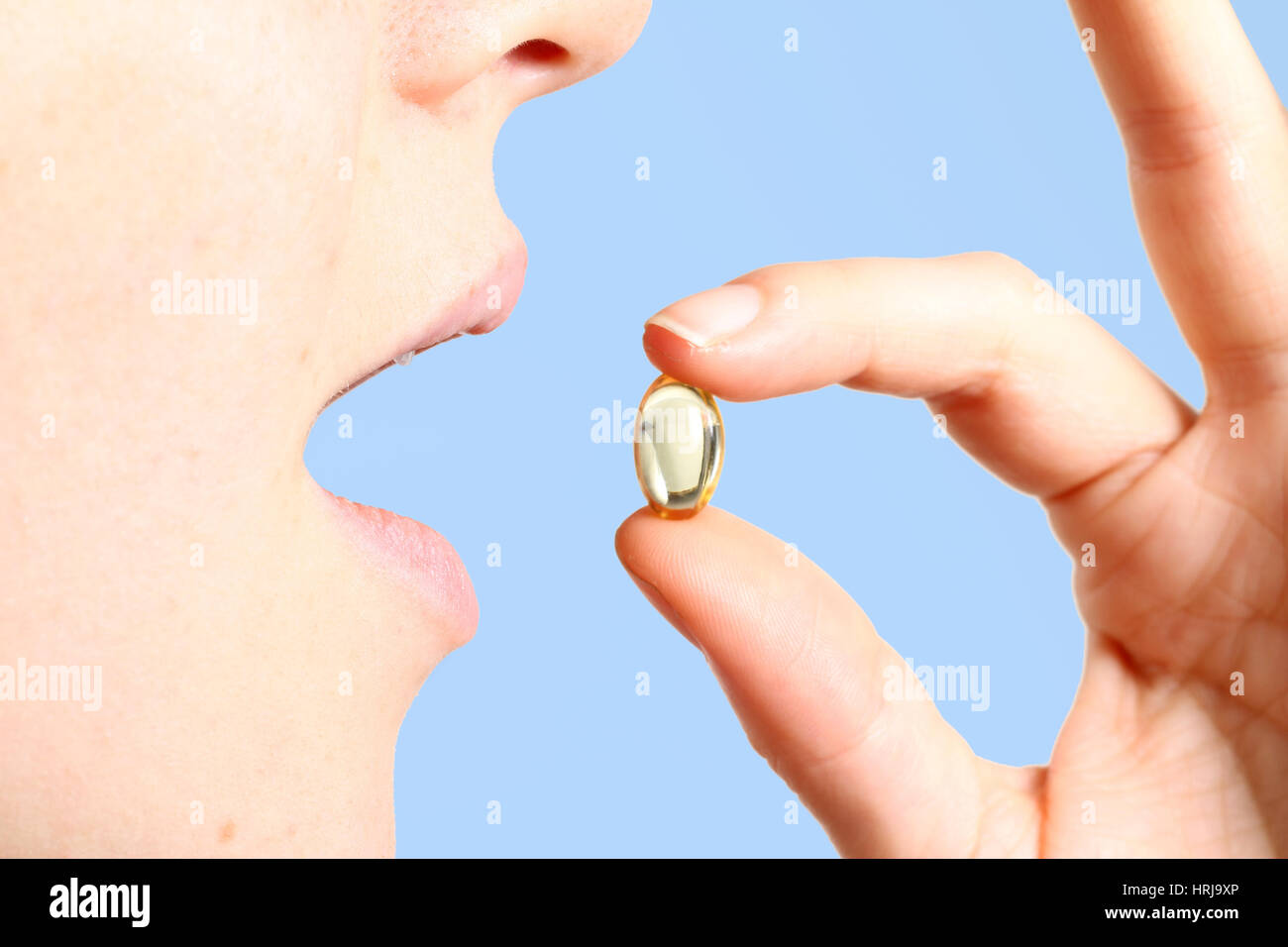 Woman taking Vitamin E Stock Photo Alamy