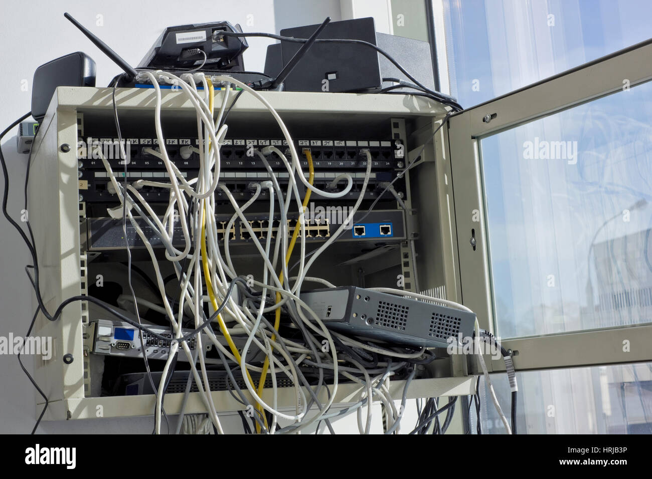 Old dusty routers and network switching internet panels hang on a ...