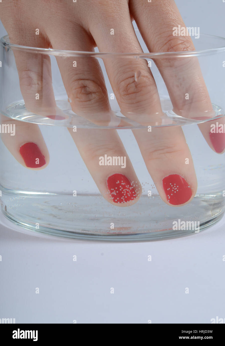 Fingers in Water Showing Refraction Stock Photo