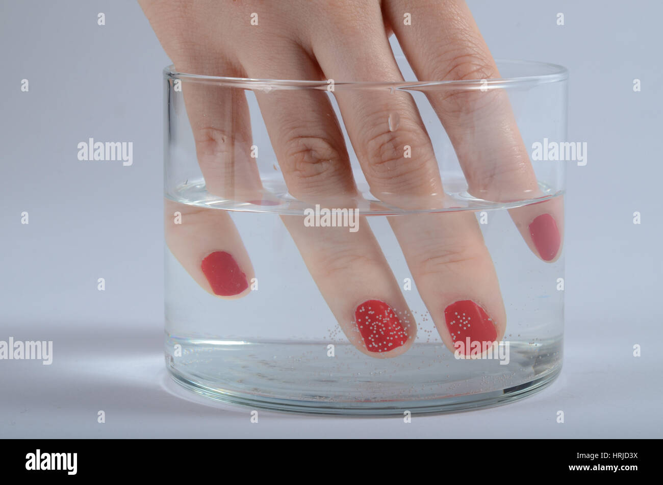 Fingers in Water Showing Refraction Stock Photo