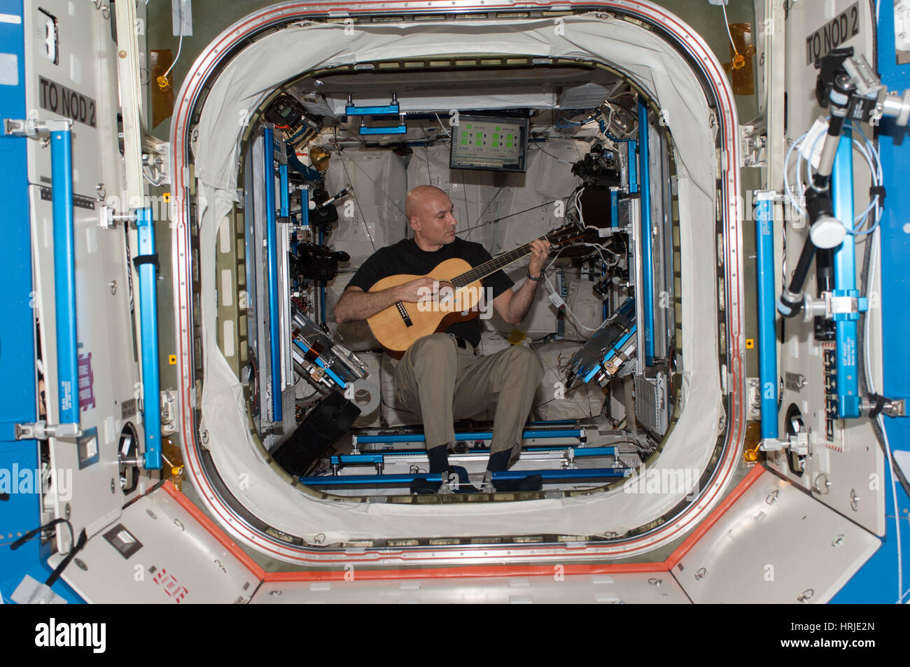 Astronaut Plays Guitar In Space Stock Photo