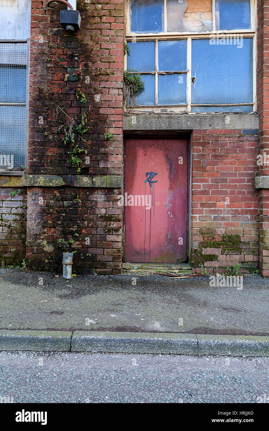 Decaying doorway to abandoned mill Stock Photo