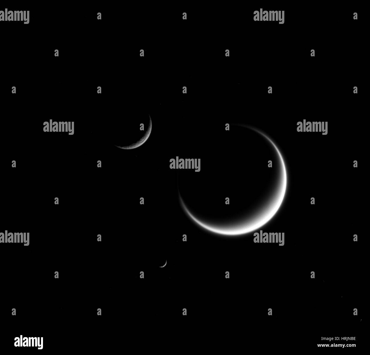 Saturn, Three Crescent Moons Stock Photo
