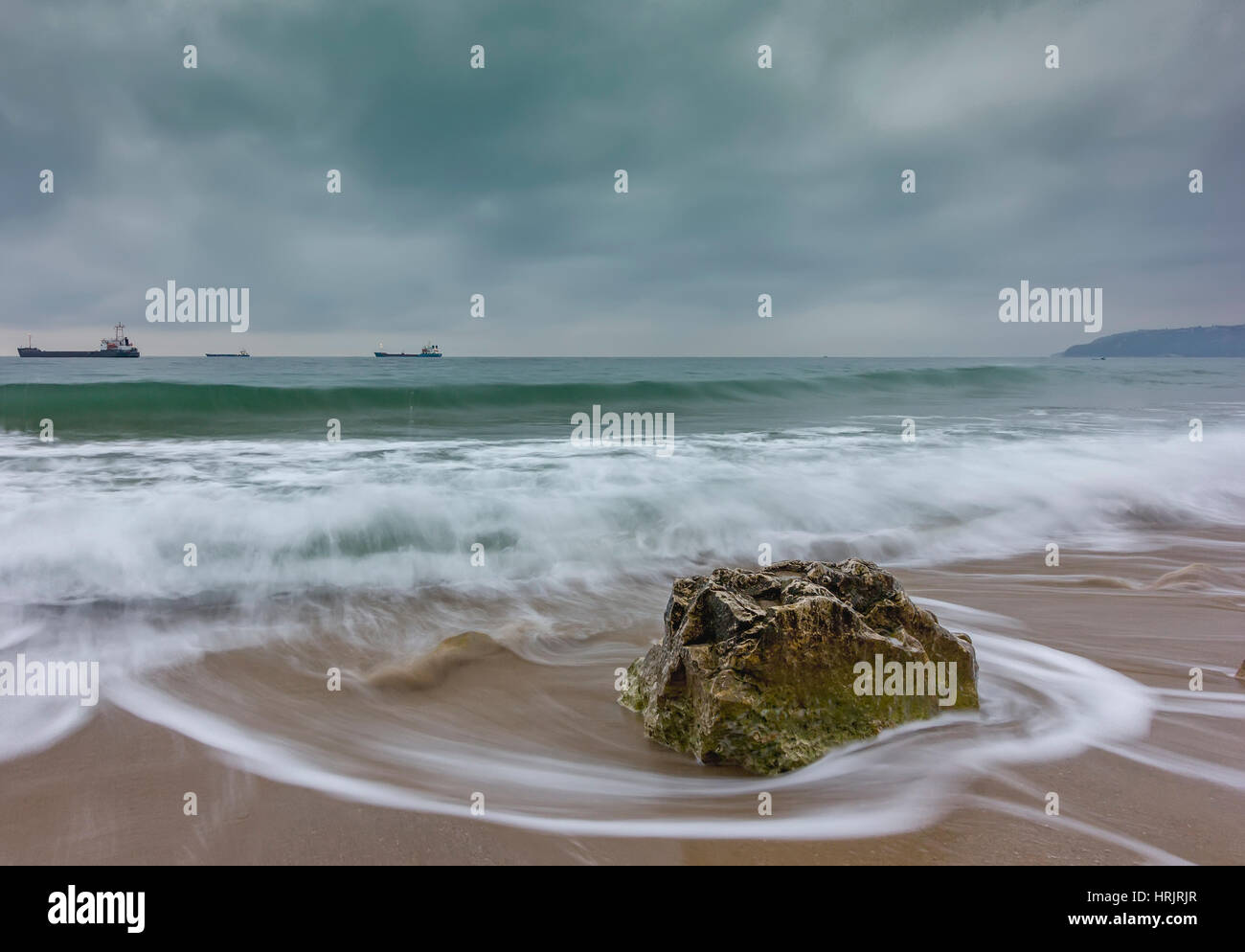Beauty cloudy, long exposure seascape with slow shutter and waves flowing out. Stock Photo