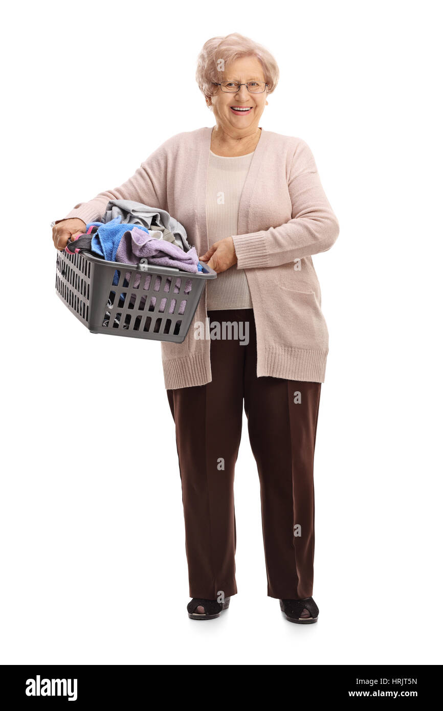 Full length portrait of a mature woman holding a laundry basket filled with clothes isolated on white background Stock Photo
