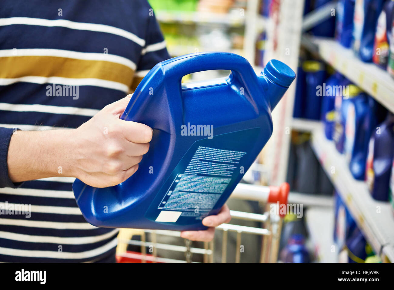 Man choices engine oil in the supermarket Stock Photo