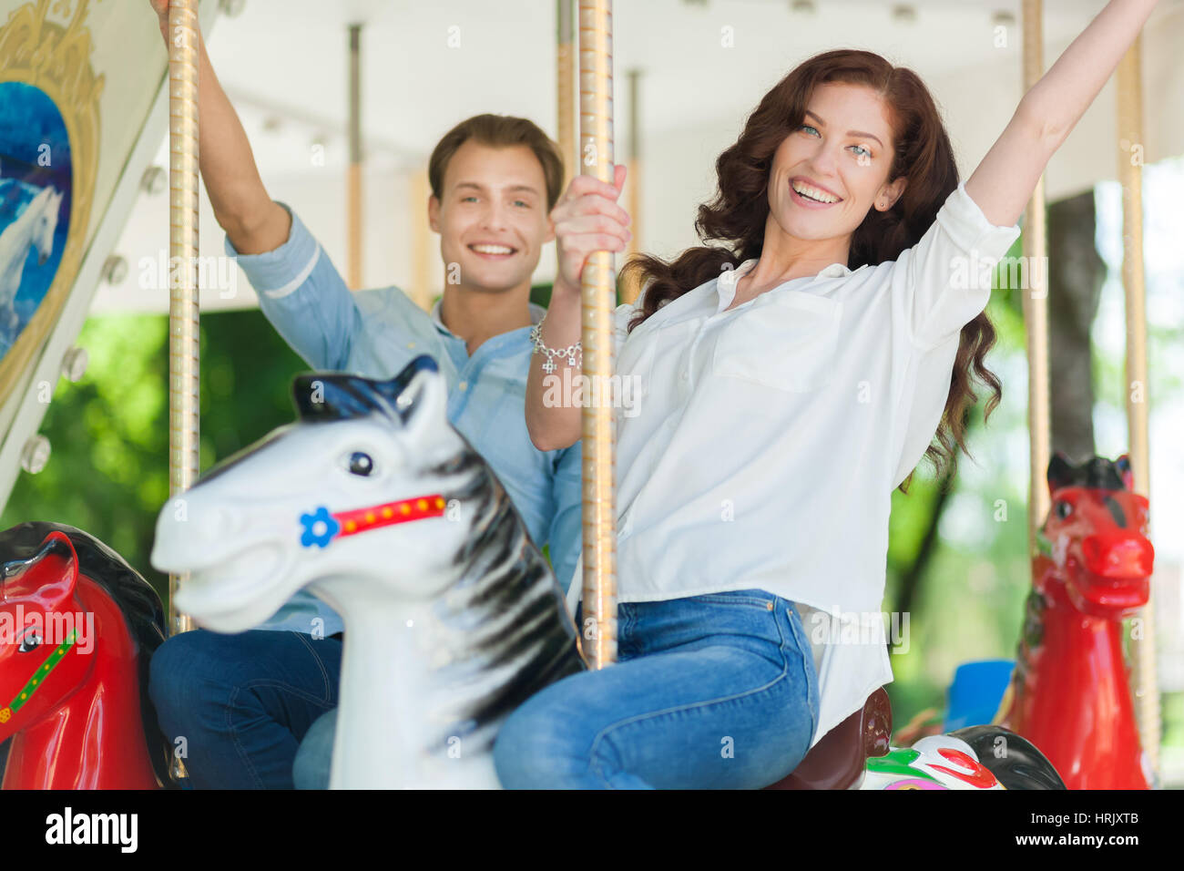 Happy couple having fun on a rollercoaster Stock Photo - Alamy