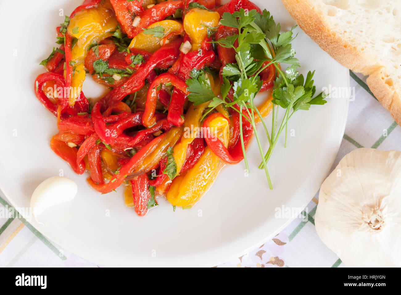 Dish of red and yellow peppers with parsley and garlic Stock Photo - Alamy