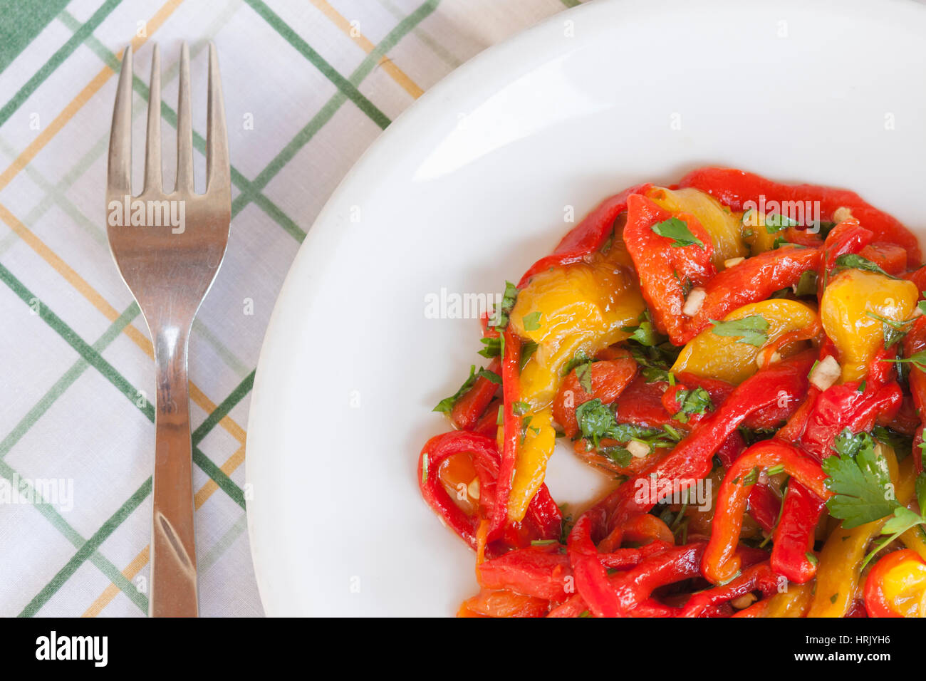Dish of red and yellow peppers with parsley Stock Photo - Alamy