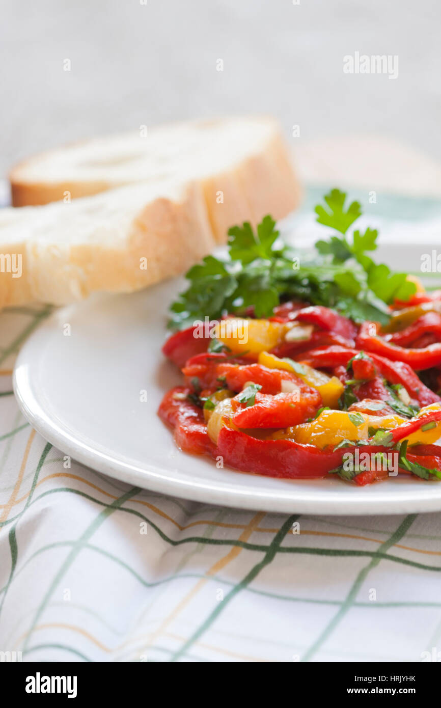 Dish of red and yellow peppers with parsley Stock Photo - Alamy