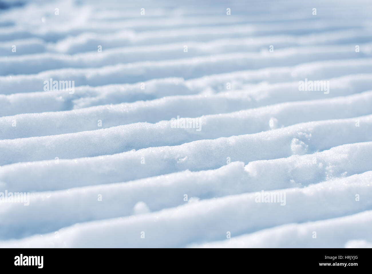 Groomed empty ski track, corduroy snow texture with selective focus Stock Photo