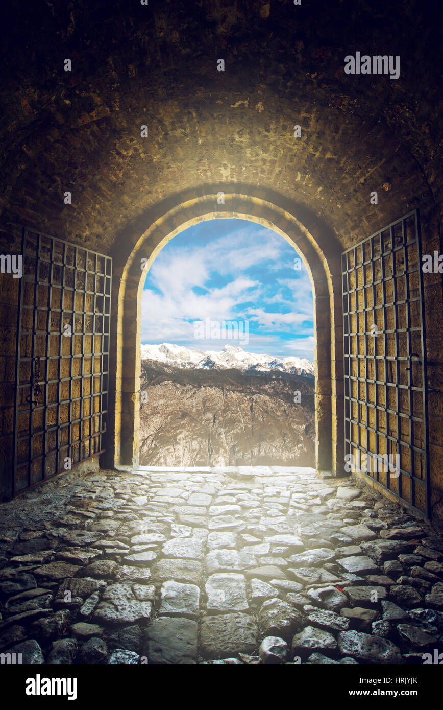 Open gate with mountain range view, endless expanse Stock Photo