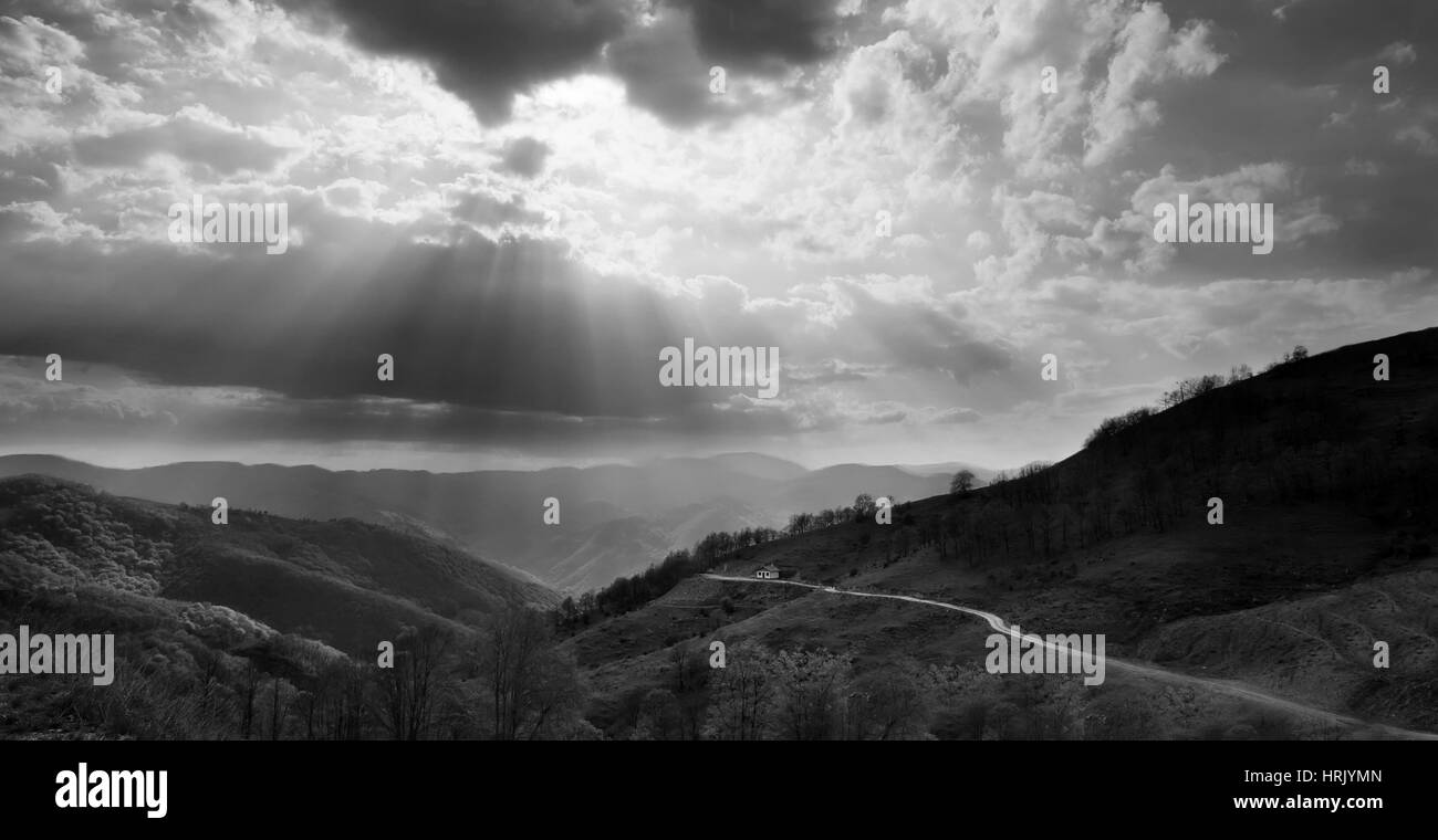 black and white landscape with sunrays over the mountains Stock Photo