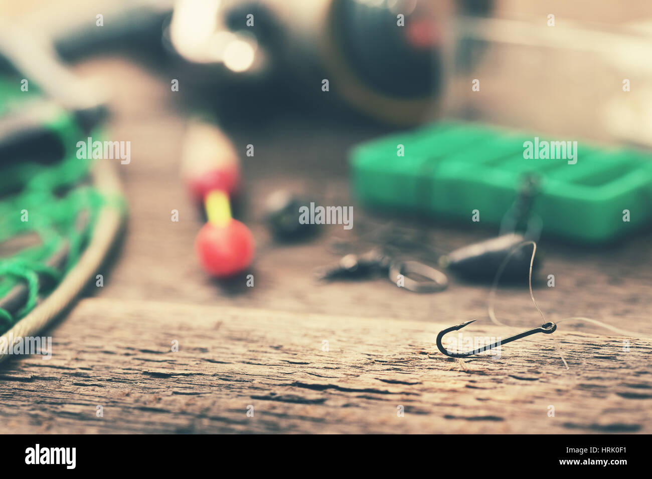 fishing hook and other equipment on old table Stock Photo