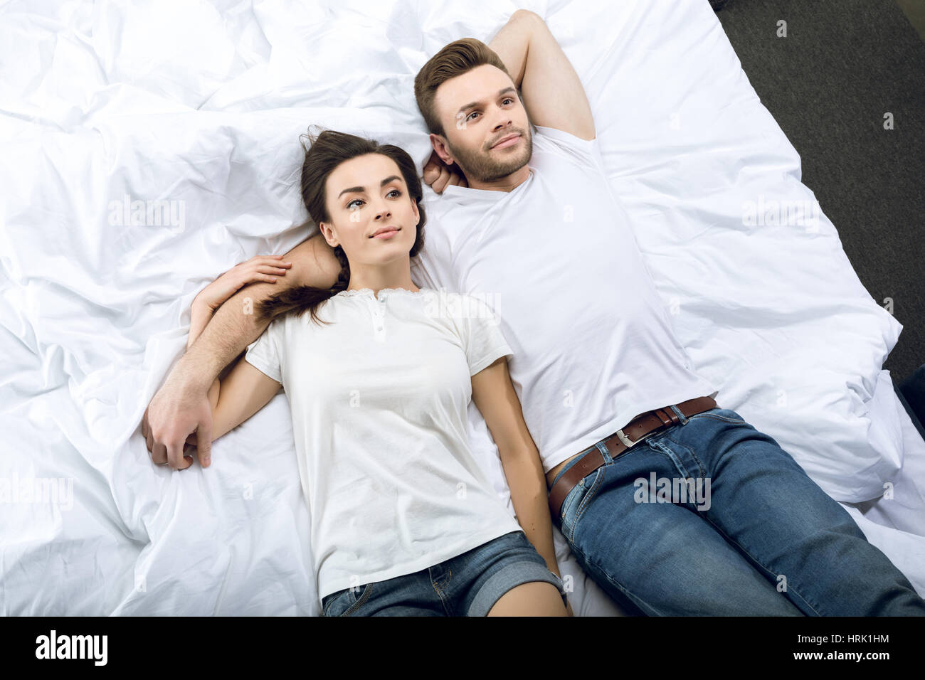 high angle view of pensive couple lying in bed Stock Photo - Alamy