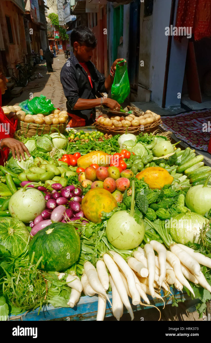 A fruit and vegetable seller and his street stall in Varanasi in India