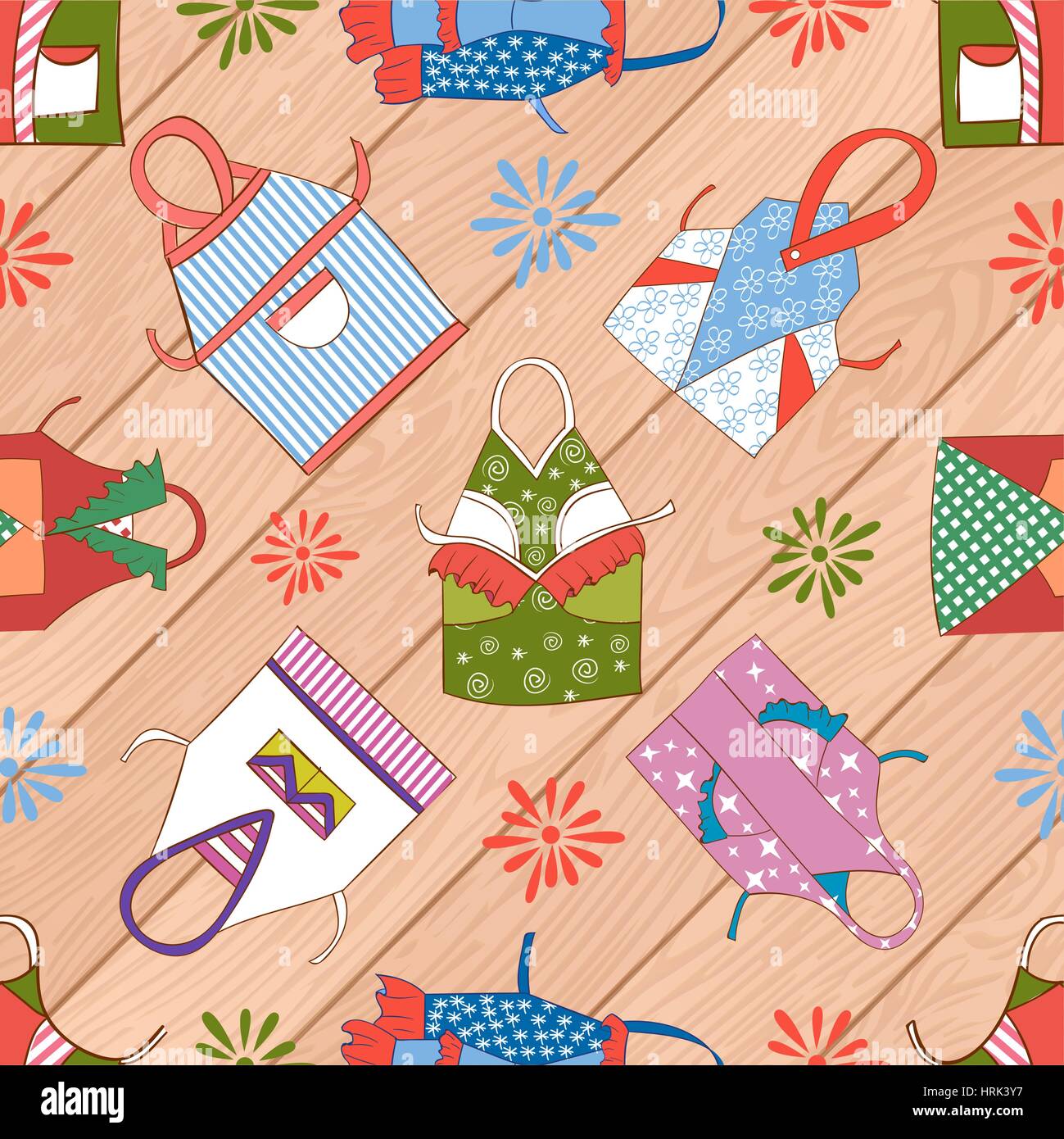 A set of colorful kitchen aprons isolated on wood, seamless background ...
