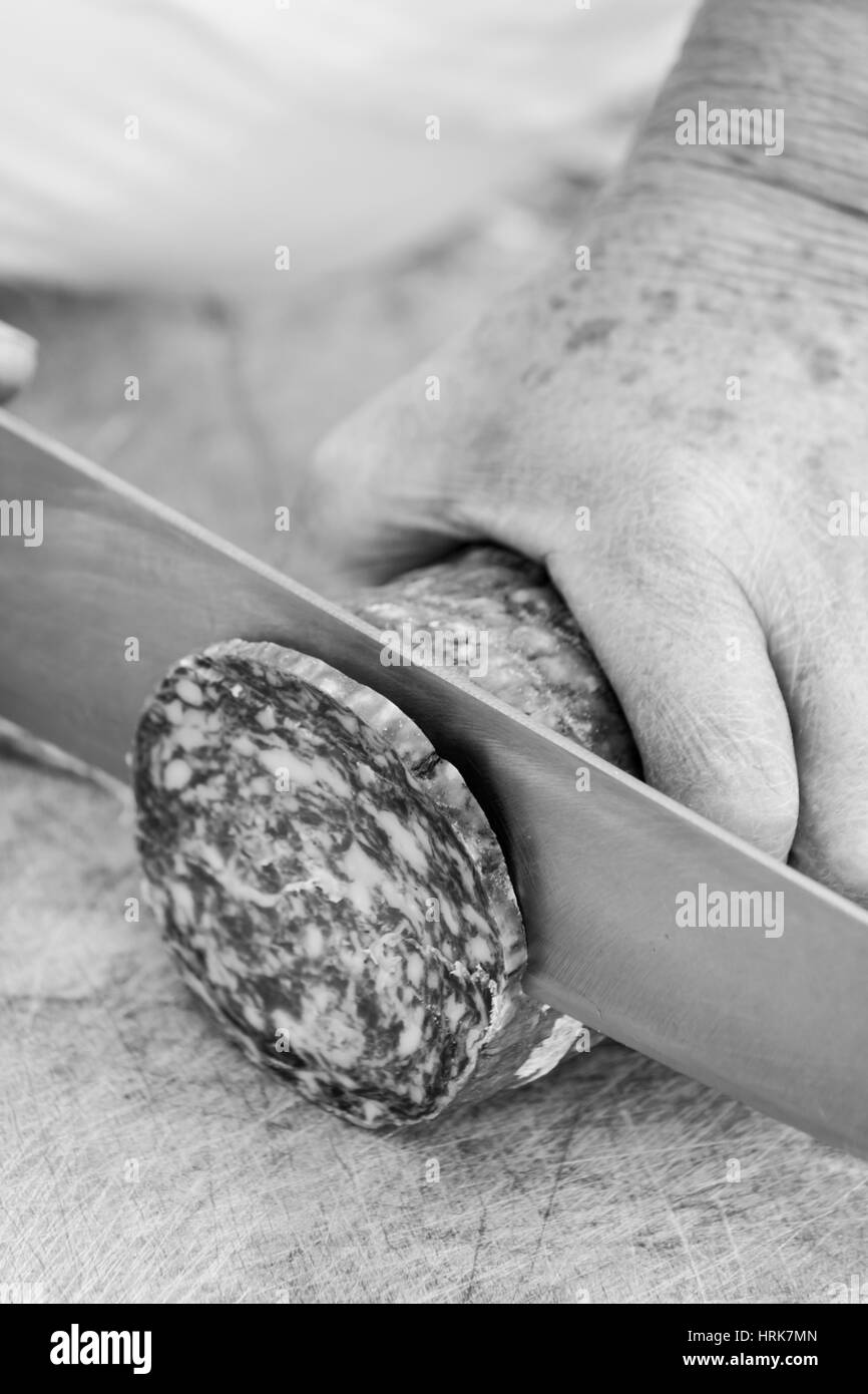 Slicing salami Stock Photo Alamy