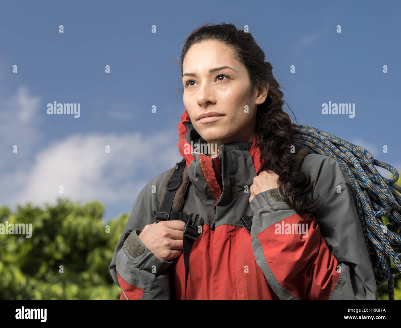 Woman mountain climber with jacket and rope Stock Photo
