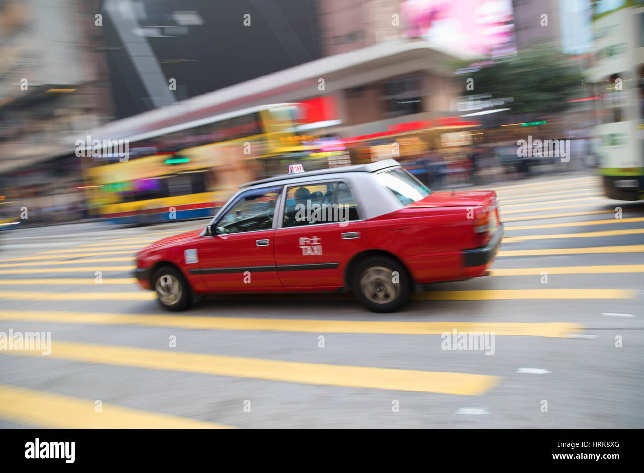 Taxi passing along street, Causeway Bay, Hong Kong Island, Hong Kong, China Stock Photo